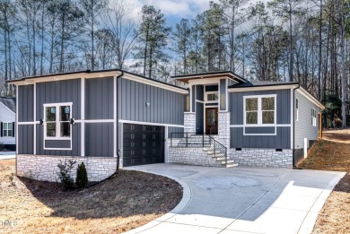 This modern custom-built home in Lake Royale is absolutely on River Golf and County Club at Lake Royale in North Carolina - for sale on GolfHomes.com, golf home, golf lot