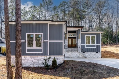 This modern custom-built home in Lake Royale is absolutely on River Golf and County Club at Lake Royale in North Carolina - for sale on GolfHomes.com, golf home, golf lot