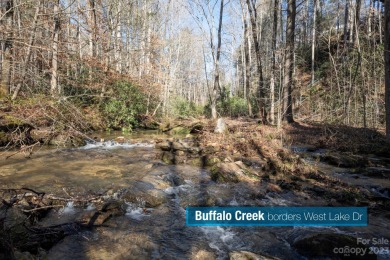 Come see this pretty, sloping lot with distant lake views on Rumbling Bald Resort on Lake Lure in North Carolina - for sale on GolfHomes.com, golf home, golf lot