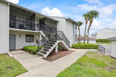 This second floor corner unit is in a gated community on Feather Sound Country Club in Florida - for sale on GolfHomes.com, golf home, golf lot