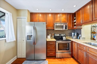 This second floor corner unit is in a gated community on Feather Sound Country Club in Florida - for sale on GolfHomes.com, golf home, golf lot