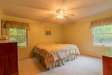 Nestled in a quiet and secluded area of Canadian Lakes, this on Canadian Lakes Country Club-The Royal Course in Michigan - for sale on GolfHomes.com, golf home, golf lot