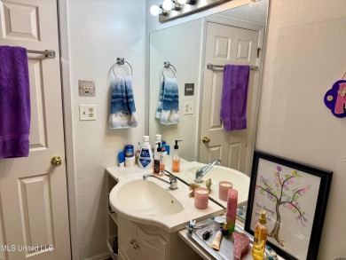 THIS UNFURNISHED 1 BEDROOM CONDO IS ON THE FIRST FLOOR AND on Diamondhead Country Club in Mississippi - for sale on GolfHomes.com, golf home, golf lot