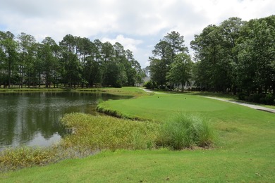 This lovely wooded, over a half acre, lot overlooks the 4th tee on Carolina National Golf Club in North Carolina - for sale on GolfHomes.com, golf home, golf lot