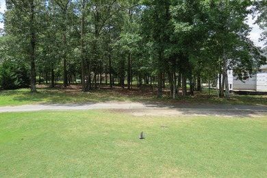 This lovely wooded, over a half acre, lot overlooks the 4th tee on Carolina National Golf Club in North Carolina - for sale on GolfHomes.com, golf home, golf lot