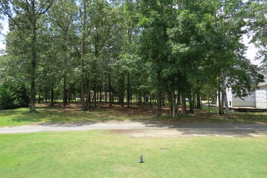 This lovely wooded, over a half acre, lot overlooks the 4th tee on Carolina National Golf Club in North Carolina - for sale on GolfHomes.com, golf home, golf lot
