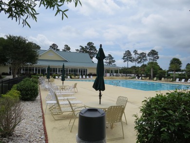 This lovely wooded, over a half acre, lot overlooks the 4th tee on Carolina National Golf Club in North Carolina - for sale on GolfHomes.com, golf home, golf lot