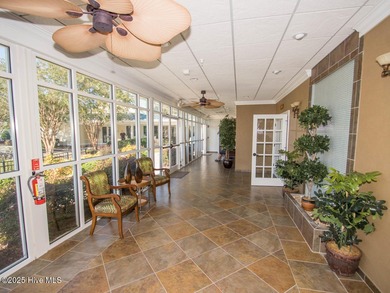 This lovely wooded, over a half acre, lot overlooks the 4th tee on Carolina National Golf Club in North Carolina - for sale on GolfHomes.com, golf home, golf lot