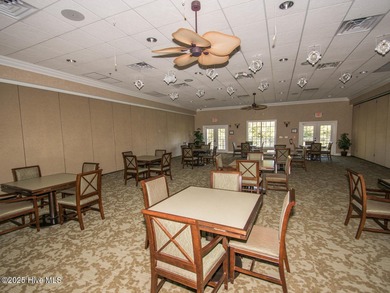 This lovely wooded, over a half acre, lot overlooks the 4th tee on Carolina National Golf Club in North Carolina - for sale on GolfHomes.com, golf home, golf lot
