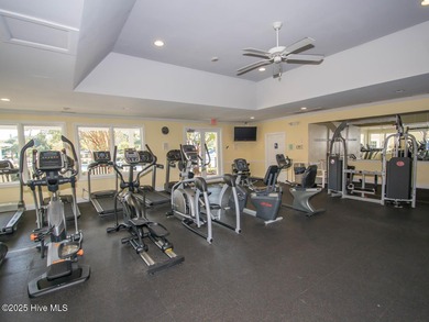 This lovely wooded, over a half acre, lot overlooks the 4th tee on Carolina National Golf Club in North Carolina - for sale on GolfHomes.com, golf home, golf lot