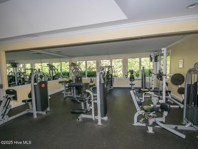 This lovely wooded, over a half acre, lot overlooks the 4th tee on Carolina National Golf Club in North Carolina - for sale on GolfHomes.com, golf home, golf lot