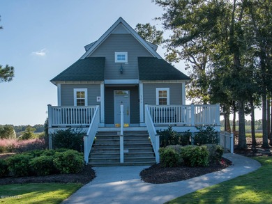 This lovely wooded, over a half acre, lot overlooks the 4th tee on Carolina National Golf Club in North Carolina - for sale on GolfHomes.com, golf home, golf lot