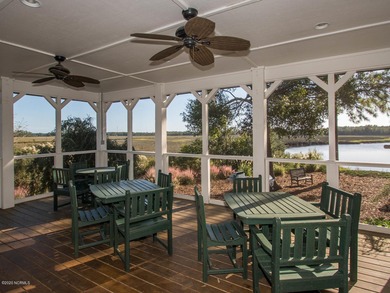 This lovely wooded, over a half acre, lot overlooks the 4th tee on Carolina National Golf Club in North Carolina - for sale on GolfHomes.com, golf home, golf lot