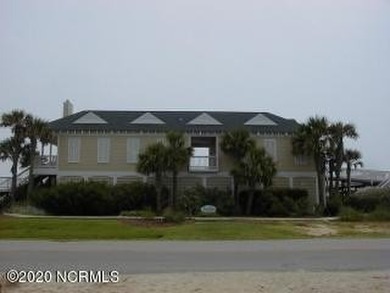 This lovely wooded, over a half acre, lot overlooks the 4th tee on Carolina National Golf Club in North Carolina - for sale on GolfHomes.com, golf home, golf lot
