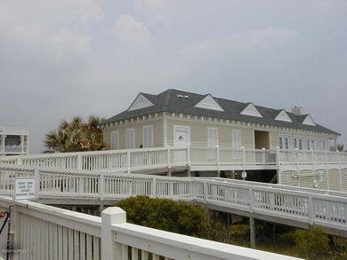 This lovely wooded, over a half acre, lot overlooks the 4th tee on Carolina National Golf Club in North Carolina - for sale on GolfHomes.com, golf home, golf lot