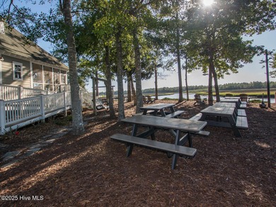 This lovely wooded, over a half acre, lot overlooks the 4th tee on Carolina National Golf Club in North Carolina - for sale on GolfHomes.com, golf home, golf lot