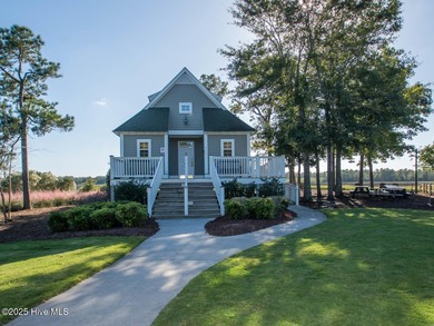This lovely wooded, over a half acre, lot overlooks the 4th tee on Carolina National Golf Club in North Carolina - for sale on GolfHomes.com, golf home, golf lot