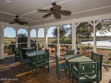 This lovely wooded, over a half acre, lot overlooks the 4th tee on Carolina National Golf Club in North Carolina - for sale on GolfHomes.com, golf home, golf lot