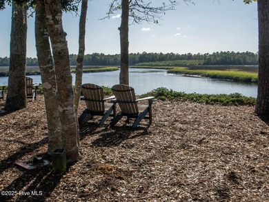 This lovely wooded, over a half acre, lot overlooks the 4th tee on Carolina National Golf Club in North Carolina - for sale on GolfHomes.com, golf home, golf lot