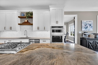 Experience elevated lake living at 244 Compass Point where on The Patriot Golf Club At Grand Harbor in South Carolina - for sale on GolfHomes.com, golf home, golf lot