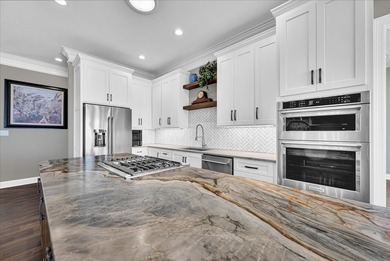 Experience elevated lake living at 244 Compass Point where on The Patriot Golf Club At Grand Harbor in South Carolina - for sale on GolfHomes.com, golf home, golf lot