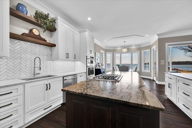 Experience elevated lake living at 244 Compass Point where on The Patriot Golf Club At Grand Harbor in South Carolina - for sale on GolfHomes.com, golf home, golf lot