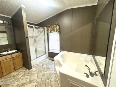 Welcome to your new home! This corner lot manufactured home in on Lake Tansi Village Country Club in Tennessee - for sale on GolfHomes.com, golf home, golf lot