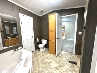 Welcome to your new home! This corner lot manufactured home in on Lake Tansi Village Country Club in Tennessee - for sale on GolfHomes.com, golf home, golf lot