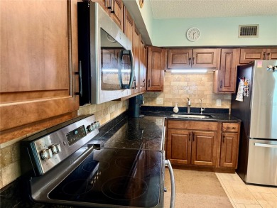 This GROUND FLOOR condo is a true gem with 1,400 sq ft of living on On Top Of The World Golf Course in Florida - for sale on GolfHomes.com, golf home, golf lot