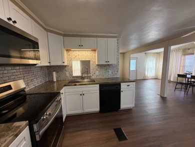 THIS LOVELY, 2/2 MANUFACTURED HOME IS ON LEASED LAND.  MONTHLY on Pine Lakes Country Club in Florida - for sale on GolfHomes.com, golf home, golf lot