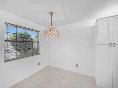 Rarely Available First Floor End Unit with views of the 7th hole on The Golf Club of Jupiter in Florida - for sale on GolfHomes.com, golf home, golf lot