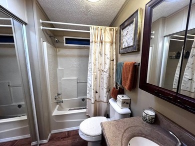 This stunning 2 bedroom, 2 bath home has been thoughtfully on Lake Henry Golf Club in Florida - for sale on GolfHomes.com, golf home, golf lot