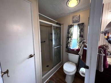 This stunning 2 bedroom, 2 bath home has been thoughtfully on Lake Henry Golf Club in Florida - for sale on GolfHomes.com, golf home, golf lot