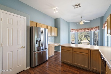 Wake up to sweeping views of the 18th tee from this impeccably on Coyote Lakes Golf Club in Arizona - for sale on GolfHomes.com, golf home, golf lot