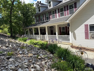 This stunning two-story home offers over 4,000 square feet of on Raintree Country Club in Missouri - for sale on GolfHomes.com, golf home, golf lot
