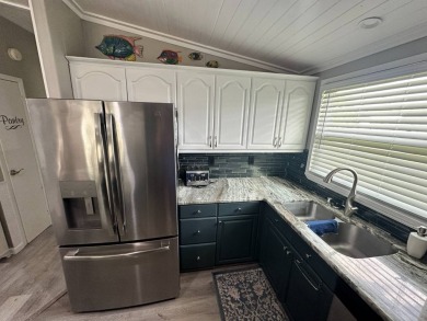 Lot Rent $1075 monthly     This beautiful 2-bedroom, 2 bathroom on Del Tura Golf and Country Club in Florida - for sale on GolfHomes.com, golf home, golf lot