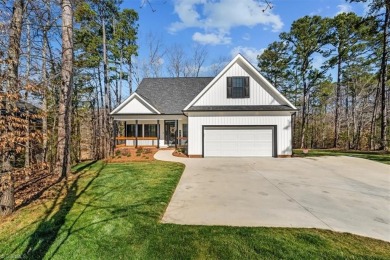 Experience luxury living on Hole #15 of the renowned Tot Hill on Tot Hill Farm Golf Club in North Carolina - for sale on GolfHomes.com, golf home, golf lot