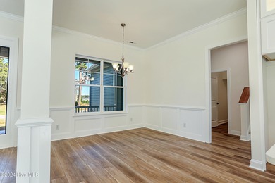 Step into paradise at 115 Genoes Point Road SW, where coastal on Lockwood Folly Country Club in North Carolina - for sale on GolfHomes.com, golf home, golf lot