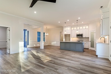 Step into paradise at 115 Genoes Point Road SW, where coastal on Lockwood Folly Country Club in North Carolina - for sale on GolfHomes.com, golf home, golf lot