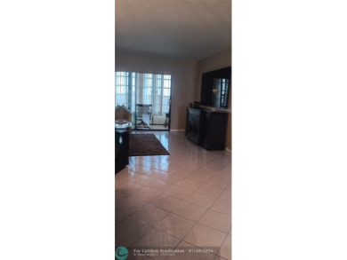 Updated 2/2 with lake view from the glass enclosed patio! on Sunrise Lakes Phase IV Golf Course in Florida - for sale on GolfHomes.com, golf home, golf lot