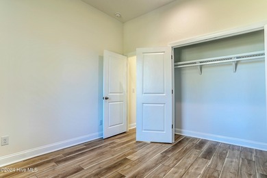 Step into paradise at 115 Genoes Point Road SW, where coastal on Lockwood Folly Country Club in North Carolina - for sale on GolfHomes.com, golf home, golf lot