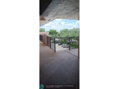 Updated 2/2 with lake view from the glass enclosed patio! on Sunrise Lakes Phase IV Golf Course in Florida - for sale on GolfHomes.com, golf home, golf lot