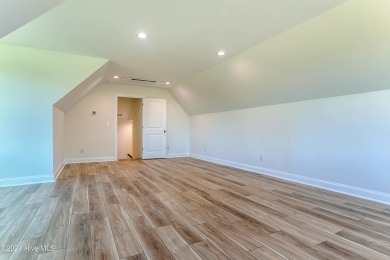 Step into paradise at 115 Genoes Point Road SW, where coastal on Lockwood Folly Country Club in North Carolina - for sale on GolfHomes.com, golf home, golf lot