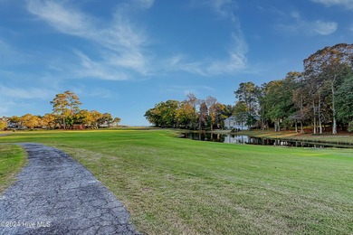 Step into paradise at 115 Genoes Point Road SW, where coastal on Lockwood Folly Country Club in North Carolina - for sale on GolfHomes.com, golf home, golf lot