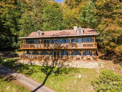 Offered FULLY FURNISHED, this stunning mountain retreat sits at on Wolf Laurel Country Club in North Carolina - for sale on GolfHomes.com, golf home, golf lot