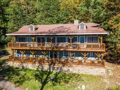 Offered FULLY FURNISHED, this stunning mountain retreat sits at on Wolf Laurel Country Club in North Carolina - for sale on GolfHomes.com, golf home, golf lot