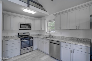 This beautifully updated and recently renovated 3-bedroom on Diamondhead Country Club in Mississippi - for sale on GolfHomes.com, golf home, golf lot