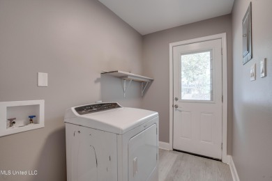 This beautifully updated and recently renovated 3-bedroom on Diamondhead Country Club in Mississippi - for sale on GolfHomes.com, golf home, golf lot