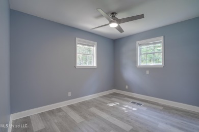 This beautifully updated and recently renovated 3-bedroom on Diamondhead Country Club in Mississippi - for sale on GolfHomes.com, golf home, golf lot