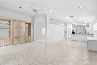Lakefront single family home nestled amongst vibrant flowering on Westchester Golf and Country Club in Florida - for sale on GolfHomes.com, golf home, golf lot